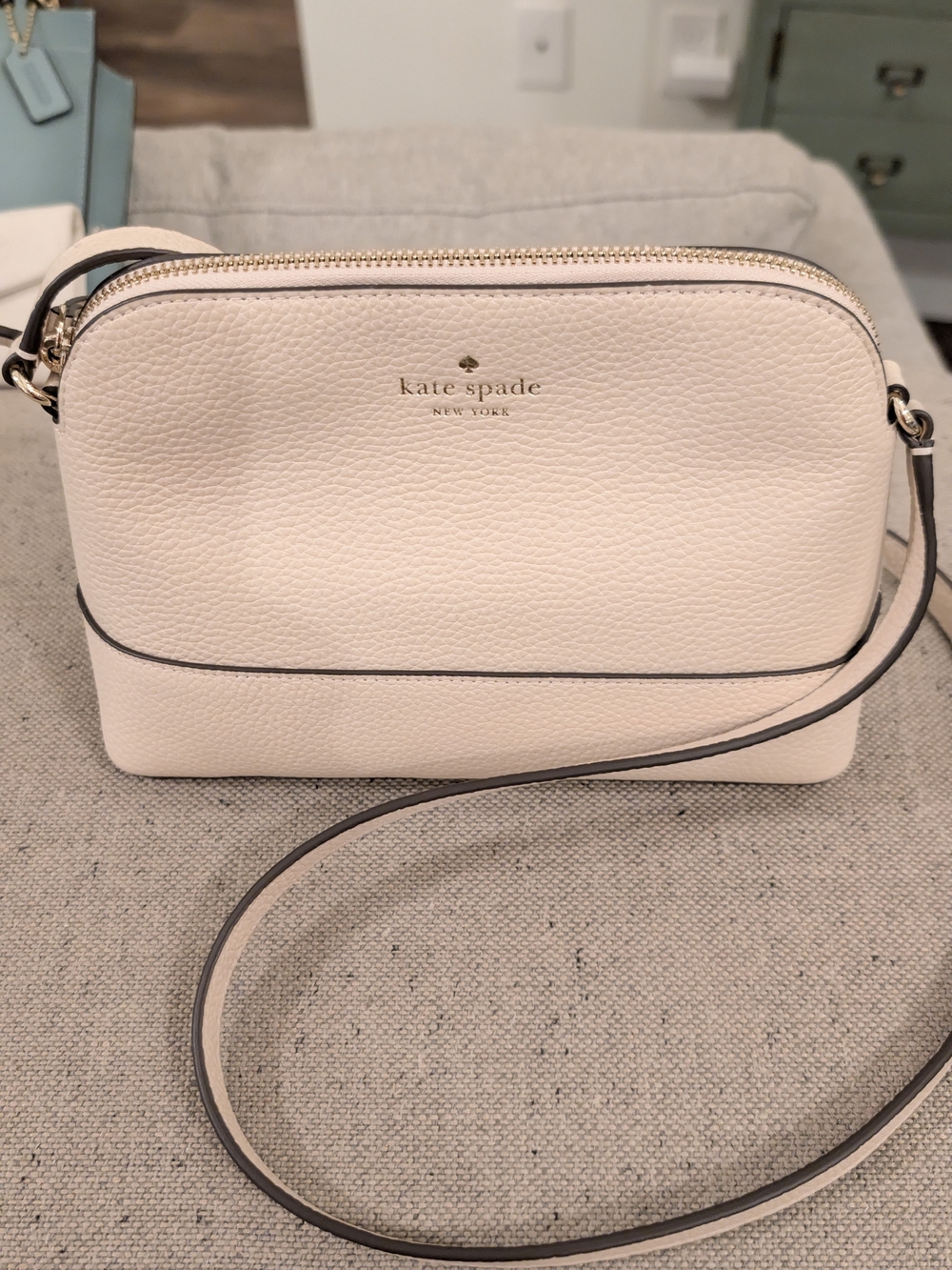 kate spade cream pebbled leather crossbody with gold logo